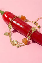 Charm bracelet with orange beads, flowers and hearts